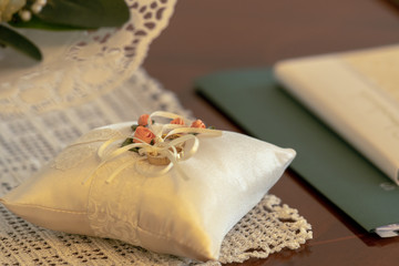 Wedding rings lie on a beautifully prepared pillow for the wedding ceremony. Concept: wedding and wedding ceremony