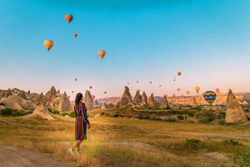 Turkey balloons Cappadocia Goreme Kapadokya , Sunrise in the mountains of Capadocia, happy young...