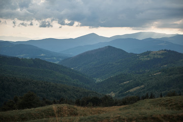 Beautiful landscape of Carpathian mountains with green vegetation and overcast sky