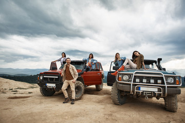 Cheerful young people resting outdoors while using their off road vehicles © Yakobchuk Olena