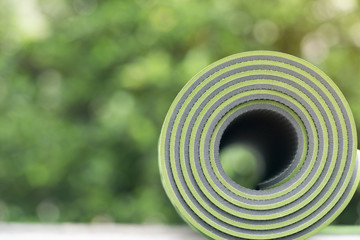 green yoga mat on table, fitness healthy and sport concept