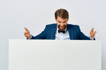 elegant man in a suit and a white sheet of paper