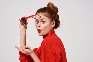 beautiful woman holding heart glasses in her hand