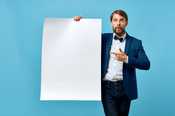 man in a suit shows his finger on a piece of paper