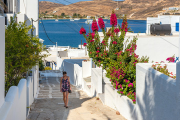 Pretty woman climbing stairs in Greece. Summer vacations. Serifos island.Greece
