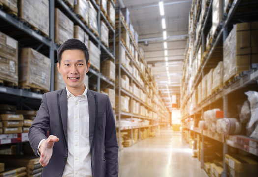 Business man handshake success business with warehouse image blur background