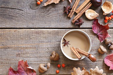 Coffee or tea with milk and spices. Rustic autumn background. Overhead view, copy space