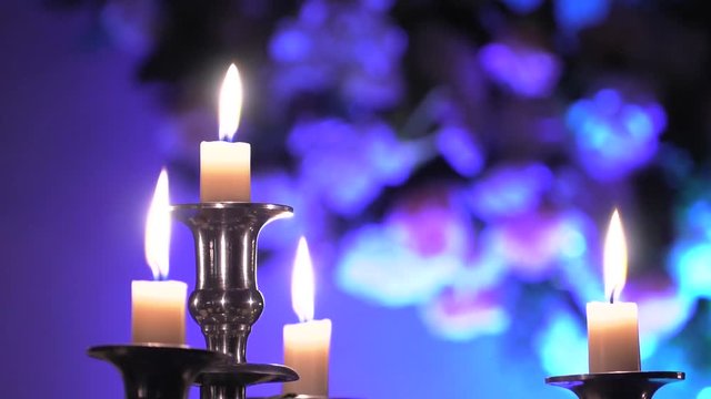 Candles burn. A warm fire. Decorating the wedding hall. 