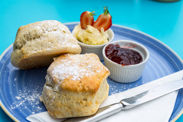 english cream tea with scones, clotted cream, marmelade and tea