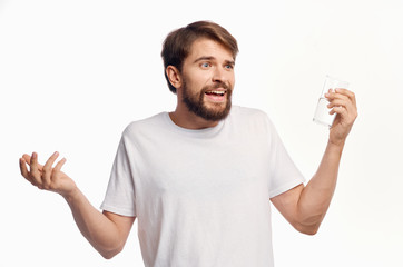 a glass of water in the hand of a man