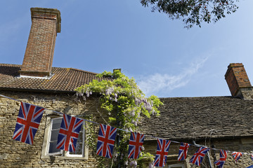 Union Jack national english flag in front of historic farmhouse