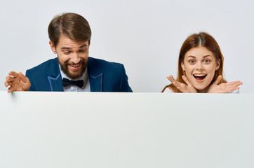 happy young people on a light background holding a sheet of paper in hand