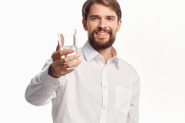 a glass of water in the hand of a handsome man