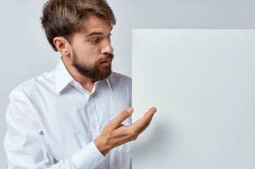 puzzled look man with white sheet of paper