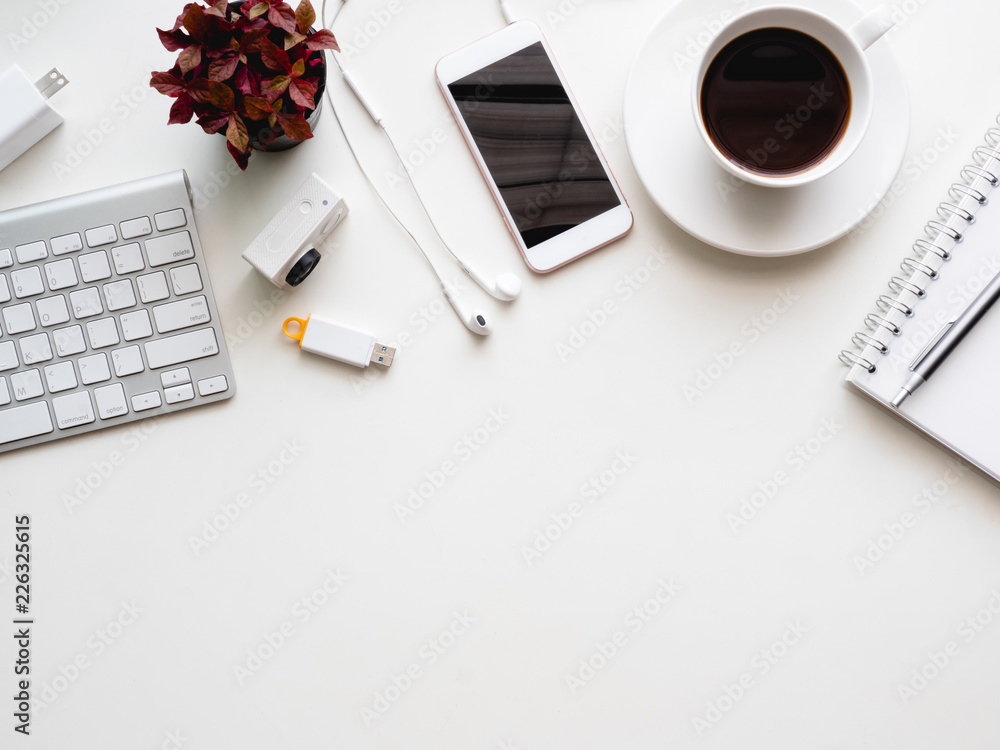 Poster top view of office desk workspace with notebook, smartphone and gadget on white background with copy