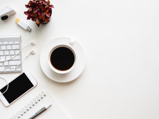 top view of office desk workspace with notebook, smartphone and gadget on white background with copy space, graphic designer, Creative Designer concept.