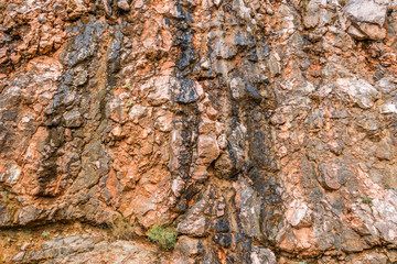 The colorful surface of the rock cliff