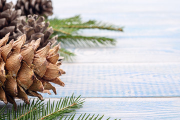 Fototapeta premium Christmas festive background - gifts and fir cones and on a blue background.