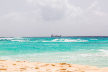 Fototapeta na wymiar Tank ship passes the Coral Mist Beach on Barbados