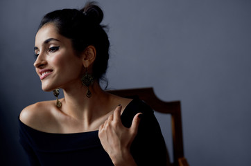 beautiful woman with bare shoulders in a dark dress