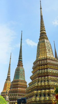 Phra Maha Chedi Si Rajakarn ,  A Group Of Four Huge Pagodas Surrounded By White Wall With Thai-Chinese Style Sheltered Gates Decorated With Colour-glazed Tiles And Chinese Rockeries Guardians.