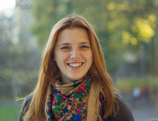 redhead girl walking in the park portrait