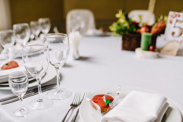  Close-up of folded napkin and empty glasses. 