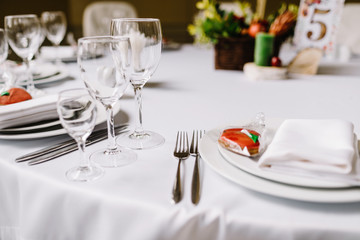 Close-up of folded napkin and empty glasses. 