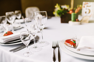  Close-up of folded napkin and empty glasses. 