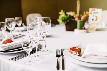  Close-up of folded napkin and empty glasses. 
