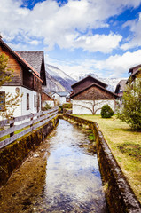 Fototapeta na wymiar Small mountain river in the village in Austria