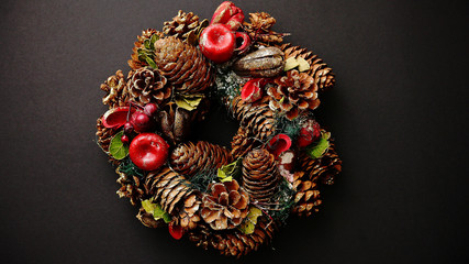 Christmas Wreath on black Background, Top View, Flat Lay, Winter Holidays Concept.
