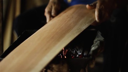 Worker Heating the Wood in the Fire. Craft Workshop of Harps in Asuncion, Paraguay. Close-Up. Full HD. 