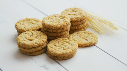 Gluten free healthy oatmeal cookies on white rustic wood bacground. Side view with copy space, flat lay.