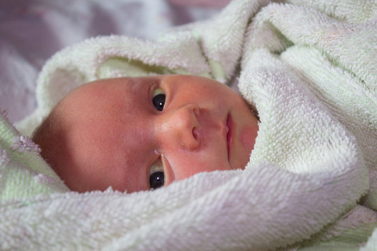 baby in a towel,newborn baby after bathing in a towel