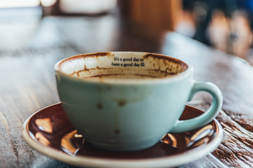 cup of coffee and beans on wooden table