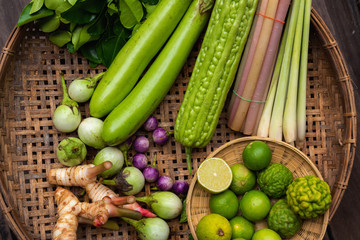 Thai Raw Ingredients Vegetables and Herbs for Thai Food in Bamboo Basket on The Table, Freshness Natural Organic Vegetable for Cooking Food. Traditional/Lifestyles of Thailand