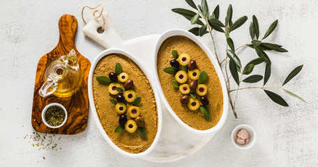 banner of vegan olives pate on a table with a branch of olive tree. healthy vegan cuisine for parties and holidays. Tapenade - obrazy, fototapety, plakaty