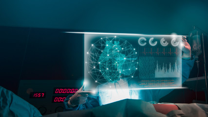 Doctor with virtual reality in operation room in hospital.Surgeon analyzing patient heart testing result and human anatomy on technological digital futuristic virtual interface,digital holographic.