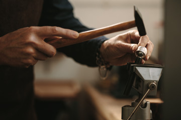 Jewelry designer shaping a ring at her workshop