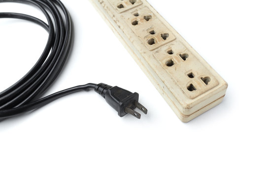 Old and unsafe power strip with illuminated switch isolated on white background