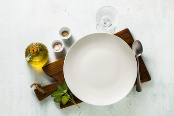 table setting. empty plates, spices, cutlery and olive oil. place to write text. copy space....