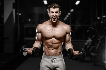Plakat sexy strong bodybuilder athletic men pumping up muscles with dumbbells