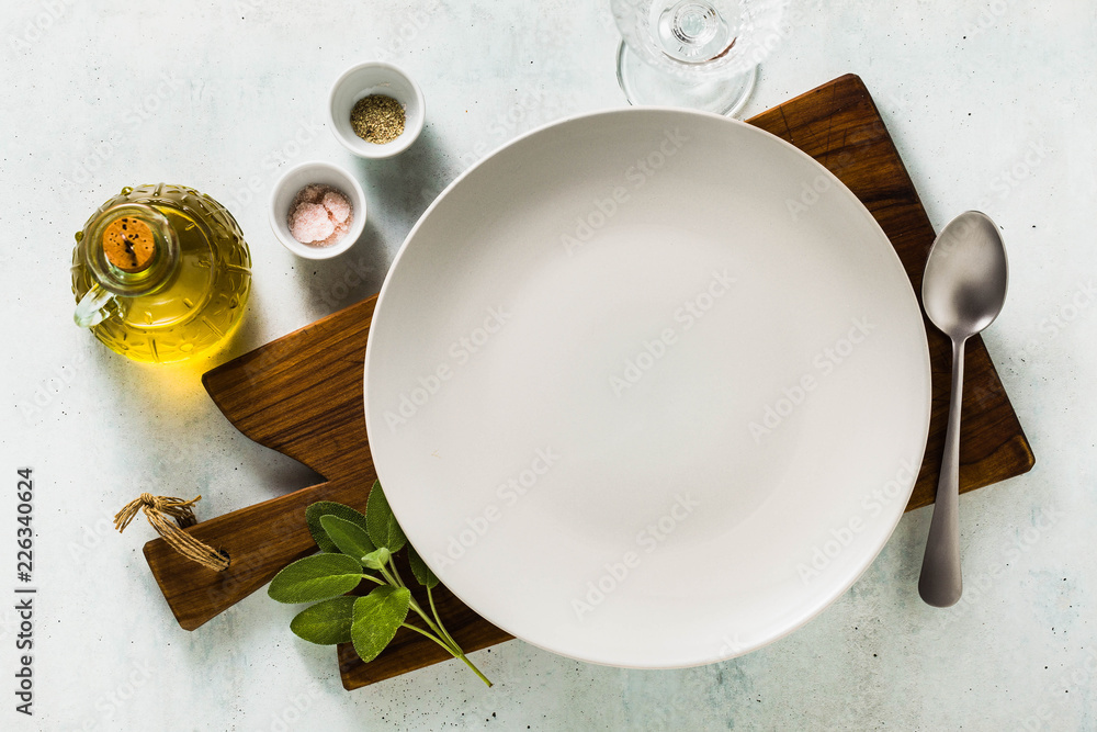 Wall mural table setting. empty plates, spices, cutlery and olive oil. place to write text. copy space. collage