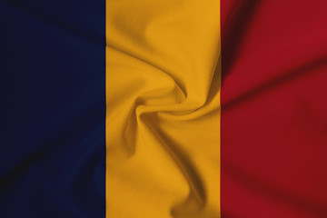 National flag of Romania on a waving cotton texture background