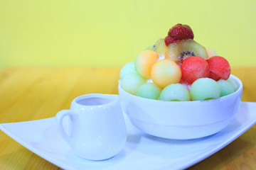 Bingsu dessert on the table, Summer season sweeten, lifestyle menu eat cooling sweet ice with delight delicious bread fruit topping and blended Peach smoothie drink, candy sweet,