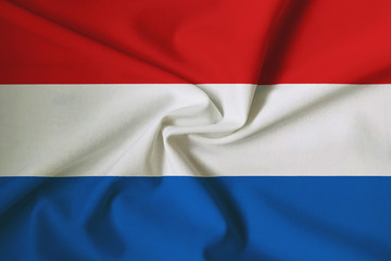 Waving Luxembourg flag with a fabric texture
