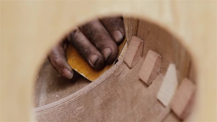 Luthier Sanding The Wood. Manufacture Of A Musical Instrument.