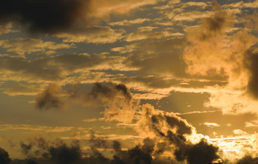 Dramatic sunset sky with orange colored clouds.
