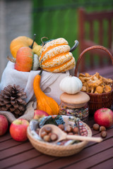 Decoration for halloween with pumpkins, nuts and flowers on the table in autumn